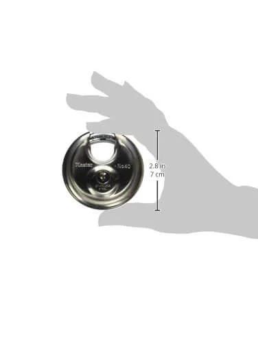 Stainless Steel Discus Padlock With Key Two And Three Quarter Inch Wide 40DPF held in hand, showing size comparison and shrouded shackle.