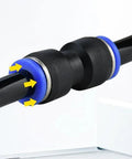 Close-up of PU4 tube fitting and PC4-M6 pneumatic straight fitting on 4mm PTFE tube; black body with blue collars