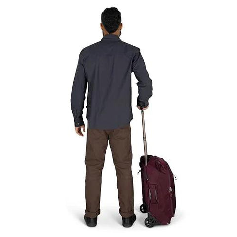 Osprey Ozone 2-Wheel Carry-On rolling luggage in burgundy with extended trolley handle, viewed from back