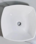 Top view of a square bathroom vessel sink, ceramic wash basin featuring a central drain hole, sleek white finish.