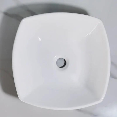 Top view of a square bathroom vessel sink, ceramic wash basin featuring a central drain hole, sleek white finish.