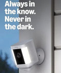 Ring Spotlight Cam Plus Battery security camera, white, wall-mounted outdoor installation.