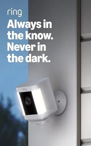 Ring Spotlight Cam Plus Battery security camera, white, wall-mounted outdoor installation.