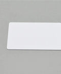 Plug And Play Blank PVC Cards For ID And Business Badges Waterproof Stock No Chip Universal Fit Smooth Printing Experience Directly Into Epson Or Canon Units Today on a gray background.