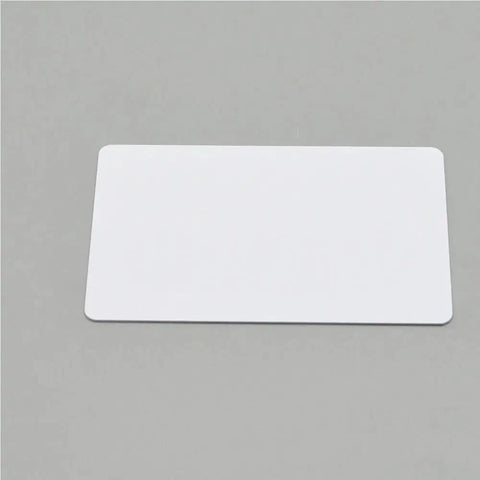 Plug And Play Blank PVC Cards For ID And Business Badges Waterproof Stock No Chip Universal Fit Smooth Printing Experience Directly Into Epson Or Canon Units Today on a gray background.