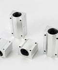 4 Pieces SCS Linear Motion Ball Slide Guides Set with LUU and UU Blocks for CNC Routers and 3D Printers Top Notch Precision Rail System for Smooth Motion and Easy Alignment in Every Project. Four aluminum linear bearing blocks on white background