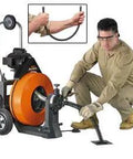 Badass Power Feed Drain Snake Machine with 100 foot cable, used by an operator for clearing blocked pipes.