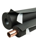 Black Pipe Insulation Closed Cell Foam Tubing One Inch Wall Thickness Self Sealing Lap Seal Kicks Pipe Sweat To The Curb, showing ends of foam tubing around copper pipe.