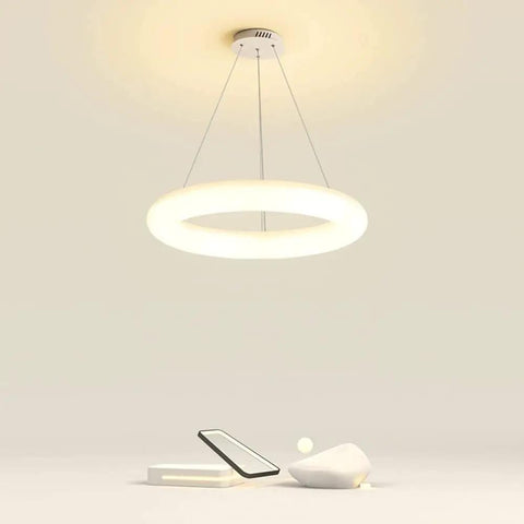 White Ring Acrylic LED Pendant Light for Bedroom, Modern Hanging Lamp, glowing on minimalist background