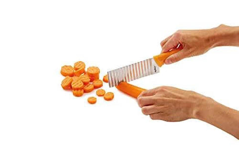 ZYLISS crinkle-cut knife side view with orange handle and stainless blade cutting carrots into crinkle slices