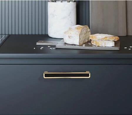 2 Pack 5.0 Inch Hole Center Zinc Alloy Square Cabinet Handles In Black Gold Finish installed on kitchen drawer.