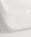 Close-up view of USZWBY Vessel Sinks Household Small Size Square Rounded White Countertop Ceramic Basin Bathroom Kitchen Sink.