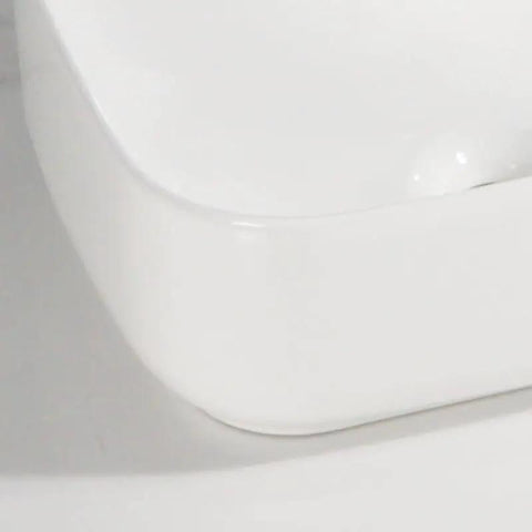 Close-up view of USZWBY Vessel Sinks Household Small Size Square Rounded White Countertop Ceramic Basin Bathroom Kitchen Sink.