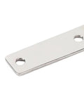 Close-up of a stainless steel T-shaped door hinge plate with two mounting holes