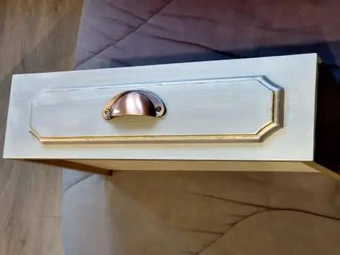 Upgrade Your Home With Hella Sturdy Iron Cup Pulls Featuring A Classic Vintage Shell Shape And Smooth Red Copper Brushed Finish Perfect For Dressers And Kitchen Drawers Ten Piece Kit on a drawer.