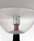 Clear plastic dust bowl attachment for hole saws with metal mandrel, front view.