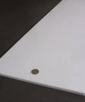 Virgin PTFE Sheet Three Eighths Inch Thick By Twelve By Forty Eight Inches Nonstick Material For High Temperature Applications Pro Grade Durable Machining And Sealing Projects, side view with coin for scale.