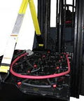 Industrial forklift battery lifting sling with yellow strap and white tag mounted on forklift battery area.