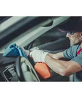 Person using Blue 14x14 Inch 100-Pack Cotton Auto Shop Towels For Detailing And Industrial Cleaning on car interior dashboard.