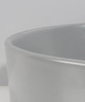Close-up of USZWBY Vessel Sinks Ceramic Vessel Sink Simple Round Matte Gray, showing smooth edge detail.