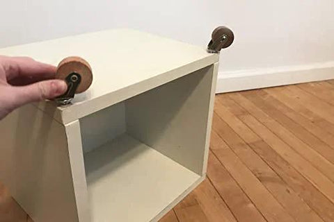Brown Wood Wheel Stem Casters Set Of Two With Friction Mount For Lightweight Furniture shown installed on wooden box.