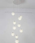 Sleek Modern Stair Chandelier Featuring Glowing Round Glass Balls And White Metal Frame, showcasing pendant lights in varying heights.