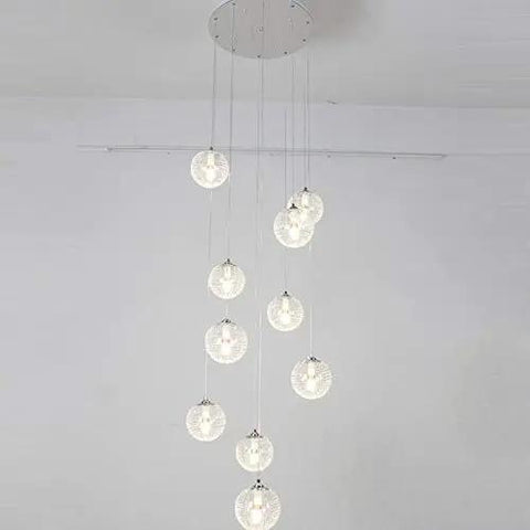 Modern Round Glass Ball Chandelier With Long Stair Pendant Light Featuring Heavy Duty Steel Frame And Premium Glass Orbs For Easy Ceiling Setup And Killer Room Glow, showcasing multiple glass orbs suspended from a ceiling mount.