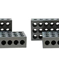 Front view of four hardened steel 1-2-3 blocks with 23 holes each for precision work