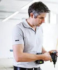 Professional 18V Cordless Drill And Driver Tool With Quick Change Chuck System Hella Versatile For Wood Metal And Garage Work Smooth Grip Fast Charge Battery Included Bright Led Light Variable Speed Trigger Top Tier Performance Rig in use by a man.