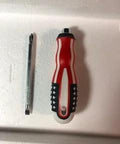Red and blue star-patterned screwdriver handle with metal bit on white surface
