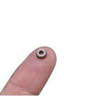 Mini Planetary Gearbox Reducer 0.3 Module 5.95mm Diameter 2.55mm Bore 18 Teeth shown on fingertip for scale