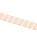 Series of rectangular beige adhesive strips arranged in a row on a white background.