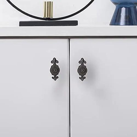 Top Notch Black Antique Mushroom Dresser Knobs With Decorative Zinc Backplates - 12 Pack shown on white cabinet doors.