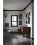 Modern bathroom featuring a bathtub, wooden vanity with sink, wall decor, and stylish lighting.