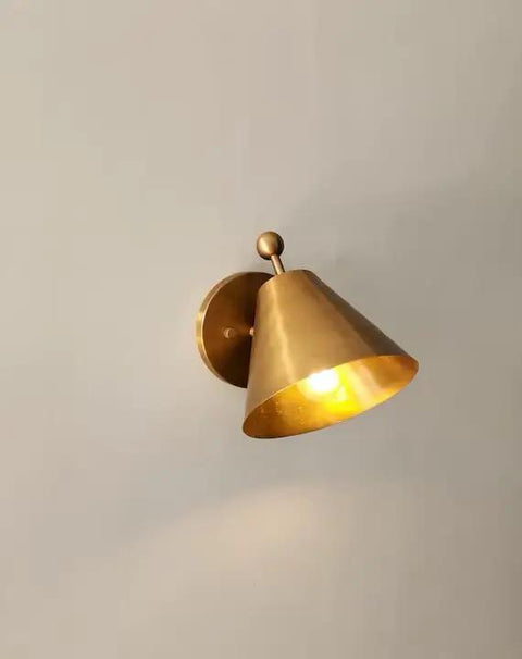 Handcrafted Brass Wall Sconce with Finial Vintage Hardwired Light in cone shape, showcasing a warm glow on wall.