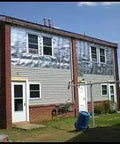Heavy Duty Reflective Insulation Roll With Foam Core Covers 400 Square Feet applied to the exterior of a residential building.