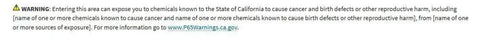 WARNING sign about chemical exposure risks, detailing potential cancer and reproductive harm in California areas.