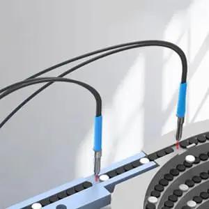 Diffuse Reflective Fiber Optic Sensor Probe With 2mm Outer Diameter, M6 Amplifier, installed on automation equipment, side view.