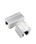 Heavy Duty 12mm Linear Ball Bearing Block For Router And CNC Machines With SBR10UU SBR12UU SBR16UU SBR20UU SBR25UU And SBR40LUU Linear Guide Rail For Smooth Sliding And Precise Motion In DIY Router Projects. Two metallic blocks with visible mounting holes and circular interior components.