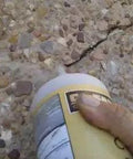 Applying Top Rated Stained Concrete Crack Filler For Driveway Patio Pool Deck Walkway Restoration Water Activated Heavy Duty Patch Mix In Mocha Brown Shade to a pavement crack.