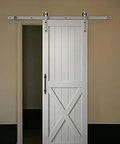 White barn door with Matte Black Barn Door Handle Set For Sliding Doors, Ultra Thin.02 Inch Backplate, mounted on wall track.