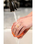 Person washing fruit under faucet wearing Waterproof Clear Bandage Assorted Sizes 100 Count With 360 Degree Seal Around The Pad