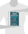 Book: The Art of Systems Architecting, Second Edition, teal cover, front view held by a person.