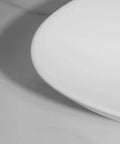 Close-up of USZWBY Vessel Sinks Bathroom Sink Triangle White Countertop Wash Basin ceramic edge detail.