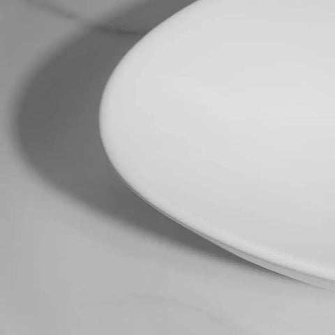 Close-up of USZWBY Vessel Sinks Bathroom Sink Triangle White Countertop Wash Basin ceramic edge detail.