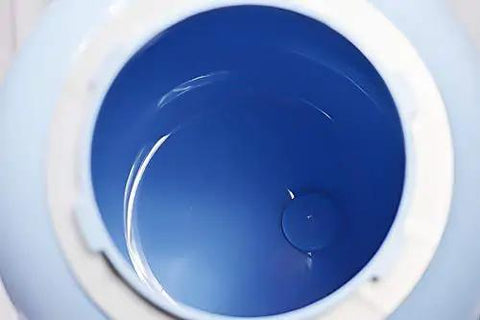 Interior view of the blue container of a Compact Manual Portable Washing Machine For Apartments And Rvs No Hookups Required Countertop Mini Clothes Washer.