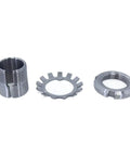 Three metal bearing adapter sleeves: split-sleeve on left, toothed ring in middle, threaded ring on right