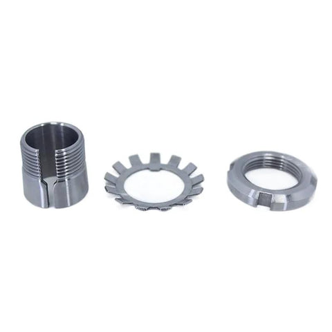 Three metal bearing adapter sleeves: split-sleeve on left, toothed ring in middle, threaded ring on right