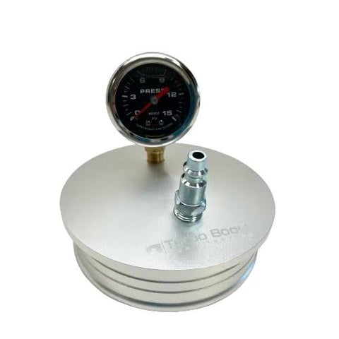 Front view of 4-inch aluminum boost leak tester end cap with 15 psi gauge and T-bolt clamp