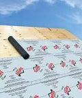 Ultra Freakin Lightweight Superior Synthetic Roofing Underlayment Heavy Duty Polymer Felt Alternative Built Like A Tank For Extreme Temperatures Rock Solid Shingle Base laid on wooden roof deck with blue sky.